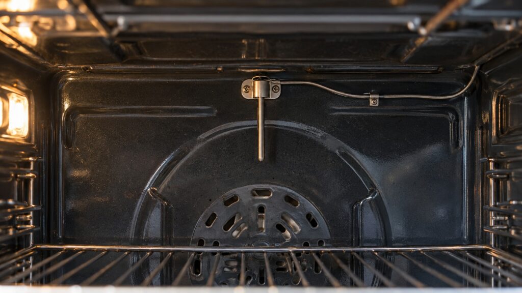 The rear upper wall of an oven cavity with the slim temperature probe mounted on it